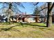 Brick ranch house with attached garage, American flag, and well-maintained lawn at 7912 E St Joseph St, Indianapolis, IN 46219