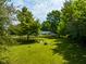 Large backyard with a wooden bridge and trees at 9191 S Tomahawk Trl, Markleville, IN 46056