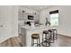 Modern kitchen island with quartz countertop and wooden stools at 11722 Cotterill Way, Indianapolis, IN 46235