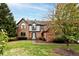 Two-story brick home with mature trees and a well-manicured lawn at 12129 Misty Way, Indianapolis, IN 46236