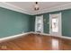 Hardwood floors and green walls in this spacious living room at 1215 E 10Th St, Indianapolis, IN 46202