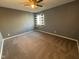 Simple bedroom with neutral walls and carpet, featuring a window with backyard view at 1258 Soaring Eagle Dr, Greenwood, IN 46143