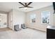 Bright bedroom featuring two windows, ceiling fan, and gray seating at 1982 Staten Ct, Westfield, IN 46074