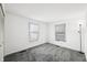 Bright bedroom with grey carpet and two windows at 2666 Lafayette Ave, Columbus, IN 47201
