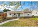 Ranch home with a covered porch and green door at 2666 Lafayette Ave, Columbus, IN 47201
