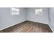 Bright bedroom with wood-look floors and two windows at 5525 W 35Th St, Indianapolis, IN 46224