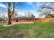 Large backyard with a brick ranch house and patio at 8037 Delbrook Dr, Indianapolis, IN 46260