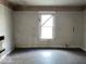 Empty bedroom with damaged walls and floors, ready for renovation at 1210 N Rural St, Indianapolis, IN 46201