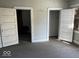 Empty bedroom with two closets and exposed floors, ready for renovation at 1210 N Rural St, Indianapolis, IN 46201