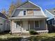 Two-story house with gray siding, a covered porch, and a gabled roof at 1210 N Rural St, Indianapolis, IN 46201