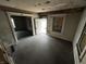 Empty living room with exposed walls and floors, ready for renovation at 1210 N Rural St, Indianapolis, IN 46201