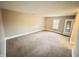 Spacious carpeted bedroom with window and door at 1632 Wellesley Ct # 6, Indianapolis, IN 46219