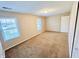 Bright bedroom with neutral walls, carpet, and two windows at 1632 Wellesley Ct # 6, Indianapolis, IN 46219
