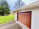Attached garage with brown overhead door and ample parking at 1632 Wellesley Ct # 6, Indianapolis, IN 46219