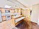 Galley kitchen with wood cabinets and breakfast bar at 1632 Wellesley Ct # 6, Indianapolis, IN 46219