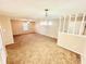 Large living room with carpet and chandelier at 1632 Wellesley Ct # 6, Indianapolis, IN 46219