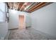 Unfinished basement room with a door to another room at 5345 Ripplingbrook Way, Carmel, IN 46033