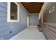 Private back patio with blue siding and a wooden privacy fence at 1213 Cottage Ave, Indianapolis, IN 46203