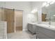 Elegant bathroom with double vanity and barn door to closet at 1213 Cottage Ave, Indianapolis, IN 46203