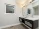 Modern bathroom with double vanity and gray tile flooring at 1213 Cottage Ave, Indianapolis, IN 46203