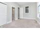 Spacious bedroom with neutral walls, carpet, and access to a bathroom at 1213 Cottage Ave, Indianapolis, IN 46203