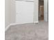 Spacious bedroom with gray carpeting and double sliding doors to closet at 1213 Cottage Ave, Indianapolis, IN 46203