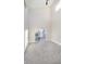 Primary bedroom with high ceilings, grey carpet, and sliding glass doors to deck at 1213 Cottage Ave, Indianapolis, IN 46203