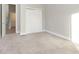 Bedroom with grey carpet, double door closet, and access to hallway at 1213 Cottage Ave, Indianapolis, IN 46203