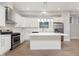 Modern kitchen with white cabinets, stainless steel appliances and an island at 1213 Cottage Ave, Indianapolis, IN 46203