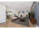Open living room showcasing kitchen, featuring hardwood floors and modern furniture at 1213 Cottage Ave, Indianapolis, IN 46203