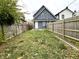 View of backyard, showing home's rear elevation and fence at 1310 N Oakland Ave, Indianapolis, IN 46201