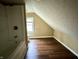 Bathroom with shower/tub, toilet, and wood-look floor at 1310 N Oakland Ave, Indianapolis, IN 46201