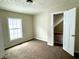 Bedroom with carpet, window, and access to attic at 1310 N Oakland Ave, Indianapolis, IN 46201