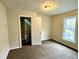 Bright bedroom with carpet, closet, and window at 1310 N Oakland Ave, Indianapolis, IN 46201