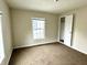 Bedroom with carpet, window, and closet at 1310 N Oakland Ave, Indianapolis, IN 46201