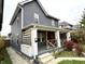 Gray duplex with white trim, side porch, and landscaping at 1310 N Oakland Ave, Indianapolis, IN 46201