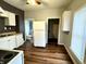 Kitchen with white cabinets and wood-look flooring at 1310 N Oakland Ave, Indianapolis, IN 46201