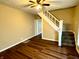 Living room with hardwood floors and staircase at 1310 N Oakland Ave, Indianapolis, IN 46201