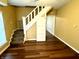 Living room with staircase and wood-look flooring at 1310 N Oakland Ave, Indianapolis, IN 46201