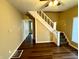 Living room with hardwood floors and staircase at 1310 N Oakland Ave, Indianapolis, IN 46201