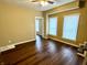 Spacious living room with two windows and wood-look flooring at 1310 N Oakland Ave, Indianapolis, IN 46201