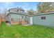 Landscaped backyard with detached garage and wooden deck at 1542 S Alabama St, Indianapolis, IN 46225