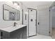 Updated bathroom, featuring a dark vanity and a walk-in shower at 1542 S Alabama St, Indianapolis, IN 46225