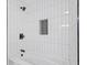 Clean bathroom with white subway tiles, black fixtures and a shower/tub combo at 1542 S Alabama St, Indianapolis, IN 46225