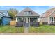 Charming green house with gray accents, a porch, and a well-maintained lawn at 1542 S Alabama St, Indianapolis, IN 46225