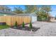 View of house exterior, detached garage, and landscaped yard at 1542 S Alabama St, Indianapolis, IN 46225