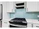 Close-up view of the kitchen stove and blue tile backsplash at 1542 S Alabama St, Indianapolis, IN 46225
