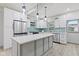 Modern kitchen with white cabinets, quartz countertops and a stainless steel range at 1542 S Alabama St, Indianapolis, IN 46225