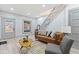 Bright living room featuring a brown leather couch, gray accent chair, and a coffee table at 1542 S Alabama St, Indianapolis, IN 46225