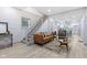 Open living area with a brown leather sofa, stylish rug, and modern decor at 1542 S Alabama St, Indianapolis, IN 46225
